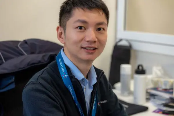 A VNS Health team member sitting at his desk.