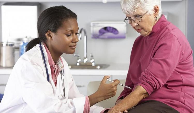 a nurse giving a flu shot