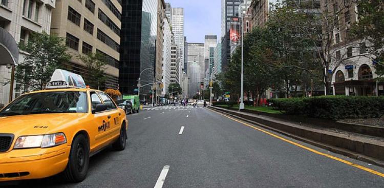 A taxi in a city during summer