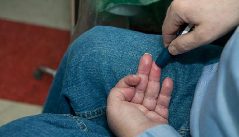 A person checking their blood sugar