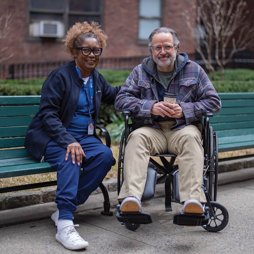 Man in wheelchair with his healthcare provider